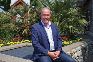 Rick Stiebel/News Gazette staff July 15, 2015 -- B.C. New Democratic Party leader and the MLA for Juan de Fuca, John Horgan, relaxes amid a tropical backdrop along Goldstream Avenue in Langford, the most populous part of his riding.